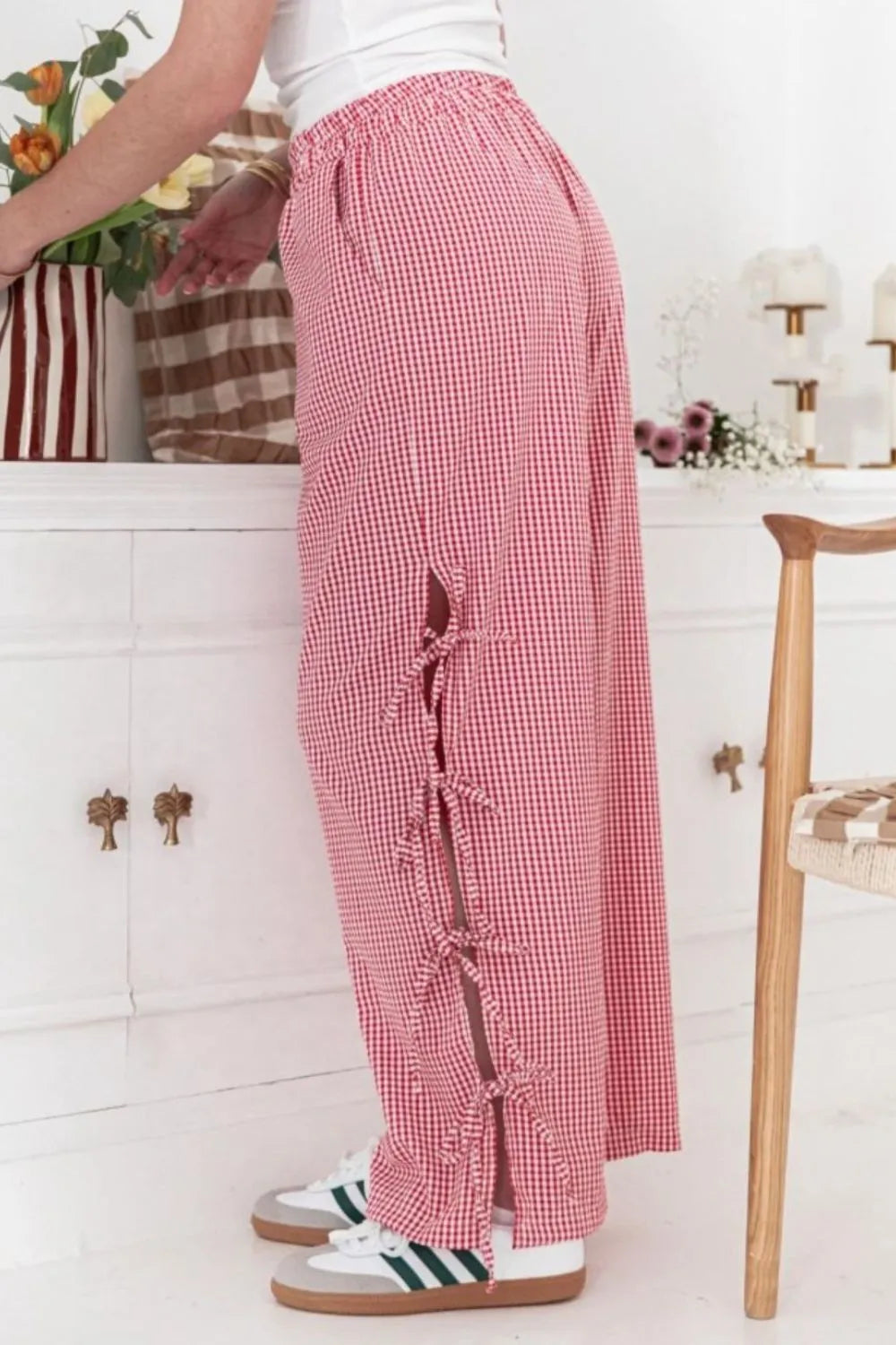 Person wearing red checkered pants with a white background